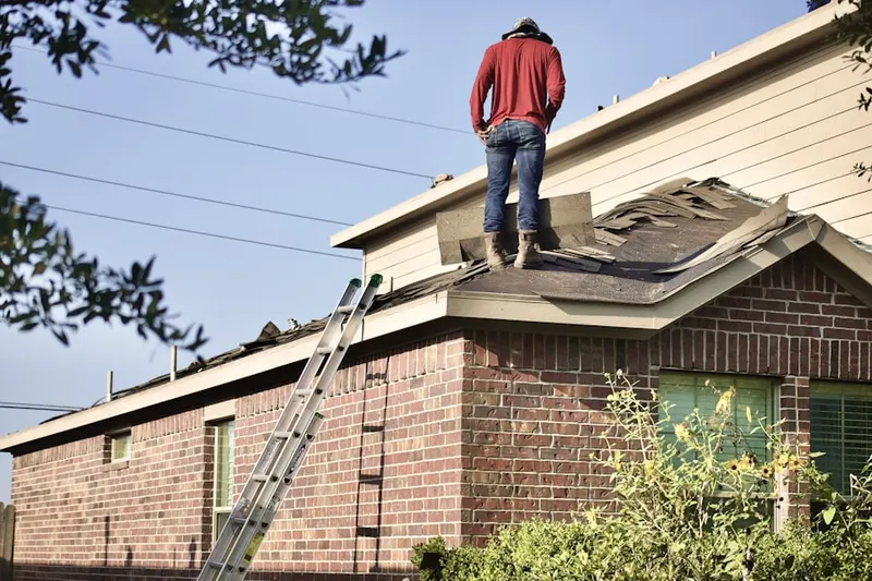 Professional roofer working on a residential roof in Maplechase